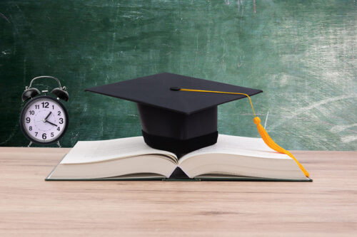 Graduation hat on top of an open book