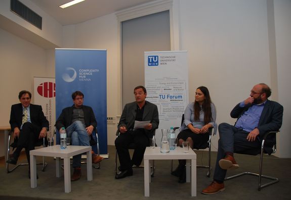 Blick auf das Podium. Von links nach rechts: Radu Groso, Peter Klimek, Norbert Fiala (Moderator), Olga Saukh und Niki Popper. Im Hintergrund steht ein Roll-Up des Clompexity Science Hubs und der TU Wien