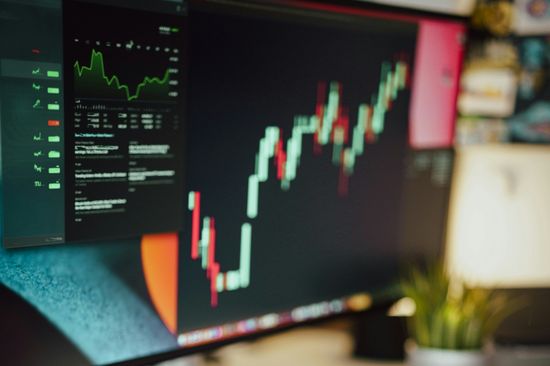 Workstation with computer, spreadsheets and calculator