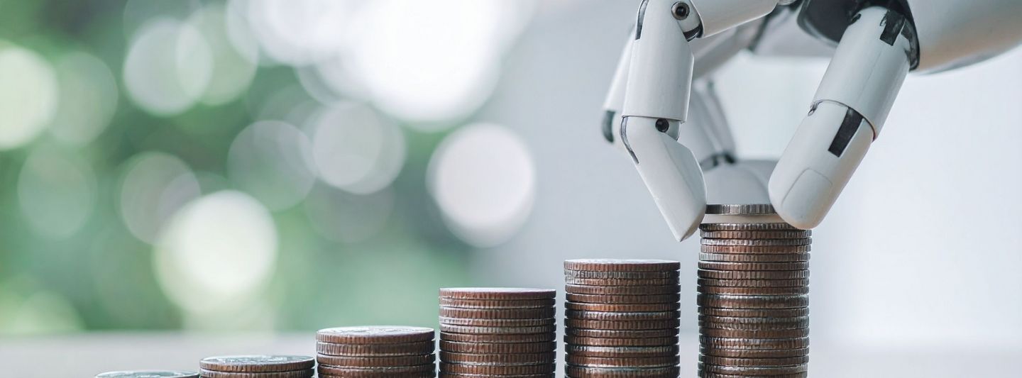 Robot hand stacking coins, symbolizing financial growth and investment
