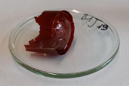 Photo of a piece of a polyimide on a glass plate  with link to PDF "Processing of polyimide films and fibers from aqueous solutions"