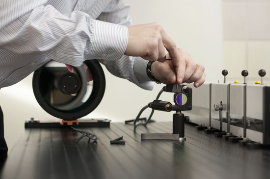 A bright laser beam hits the sample, the scattered light is collected by a telescope.