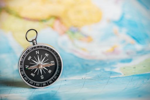 Compass in front of a world map
