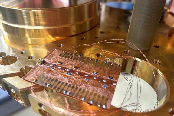 Copper sample holder with chip resistors for calibration.