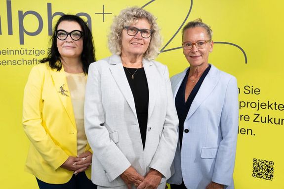 Three people in front of a yellow background