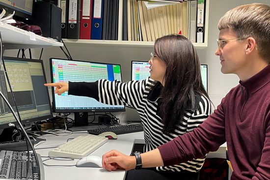 two people in front of computer screens