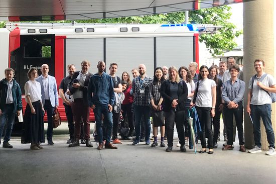 Group picture of participants in front of a fire engine at Open Science Day 2025