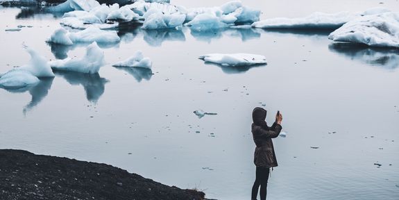 Woman with camera at a glacier