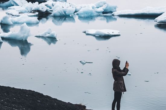 Woman with camera at a glacier