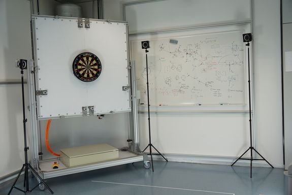 [Translate to English:] Dartscheibe auf einer Platte, Kameras auf Stativen