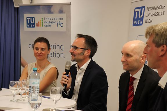 Close up of the podium. In the background you can see roll-ups of the i2c and the TU Wien.