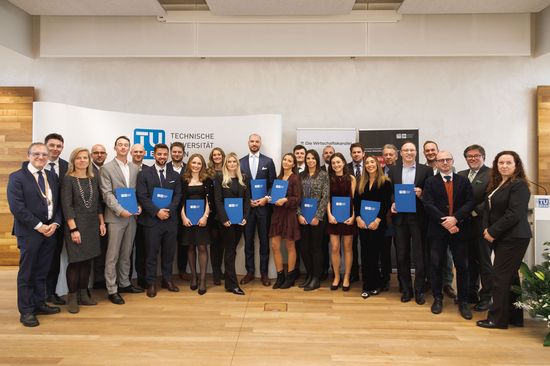 Group picture after graduation with graduates and diplomas