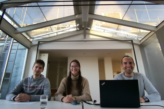 Three persons in a meeting room