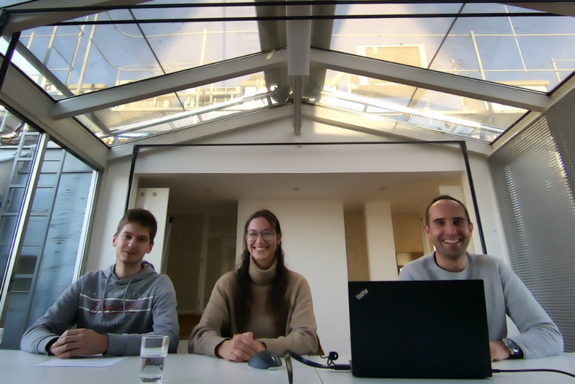 Three persons in a meeting room