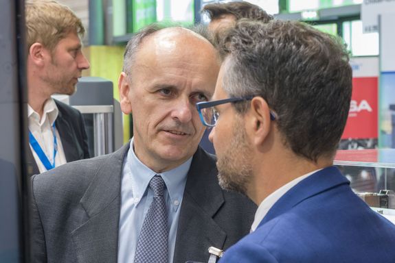 rector Johannes Fröhlich talking to a man