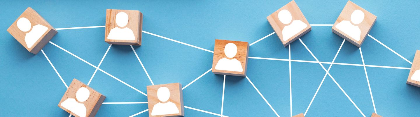 Wooden blocks connected together on a blue background. Teamwork concept