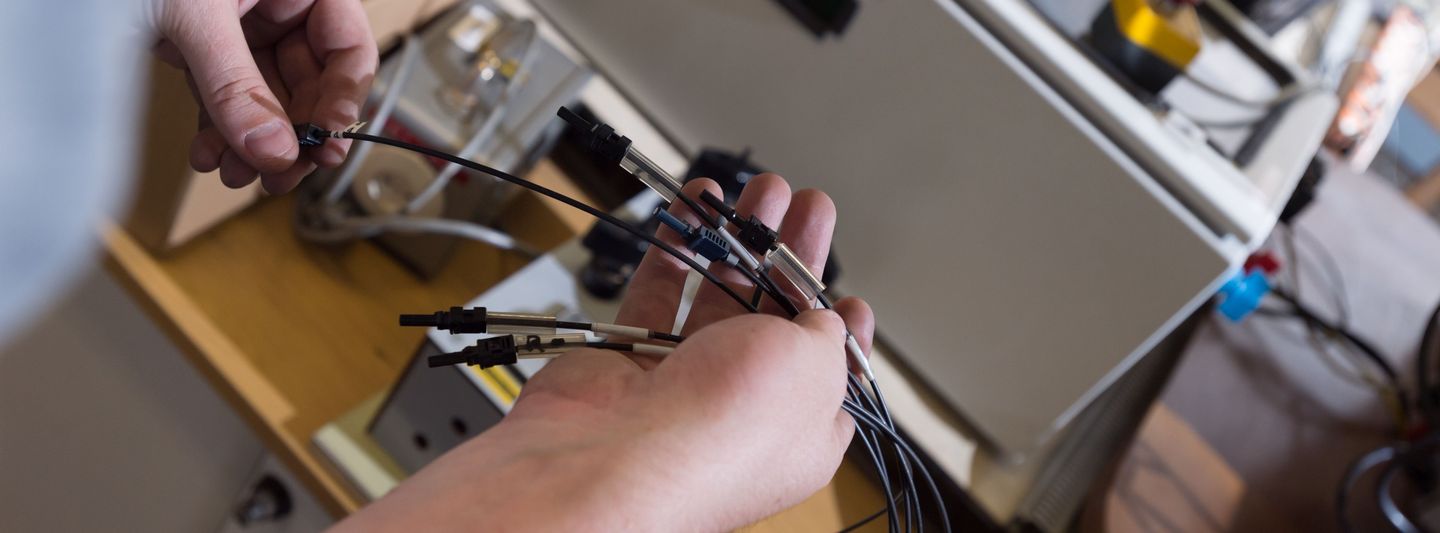 Male hand holds several different cables