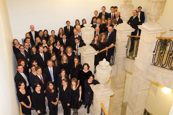 TU Orchestra A large group of people, all dressed in black, on the staircase in the TU Wien.