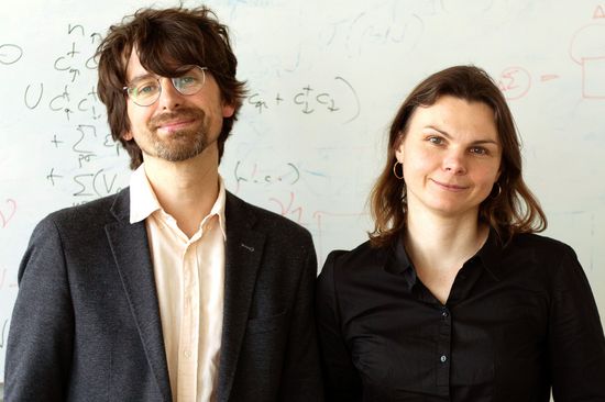 two people in front of a whiteboard