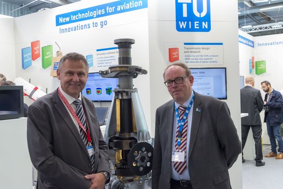two men and a gearbox in the middle at the TU Wien stand