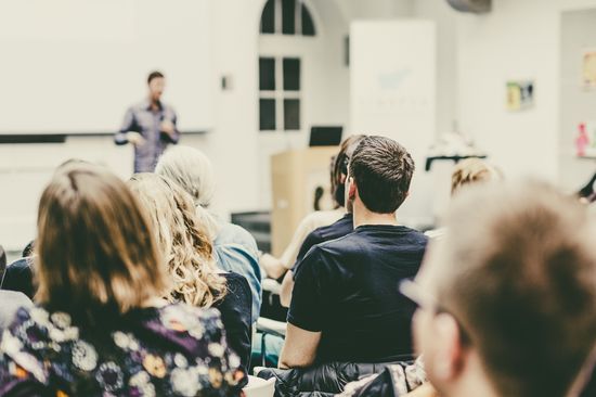 Man giving presentation in lecture hall at university.