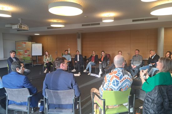  A group of people, sitting in a circle, talking