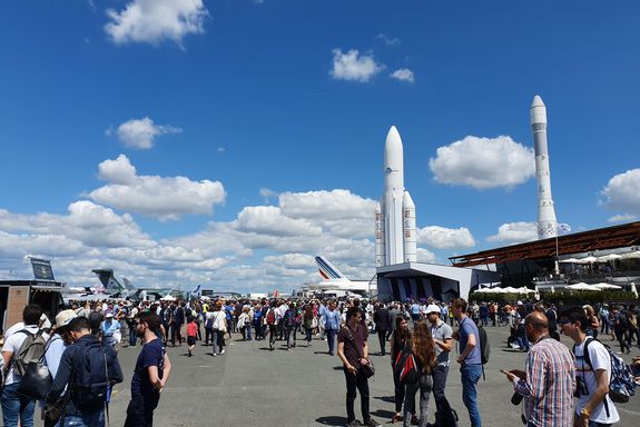 a lot of people walking at the SIAE area, two rockets in the back