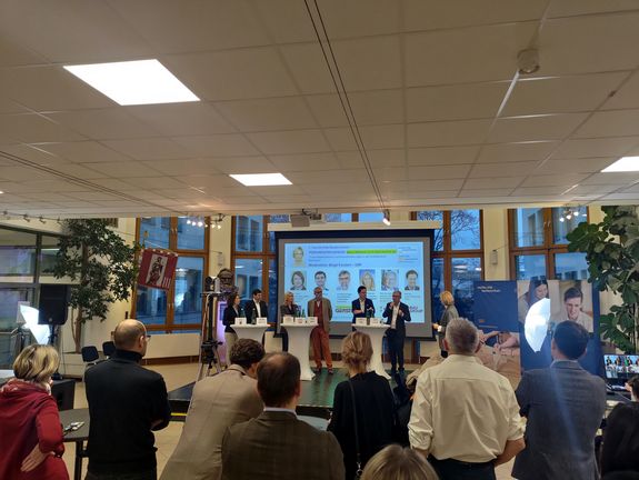 Panel discussion - stage with screen, panelists and students