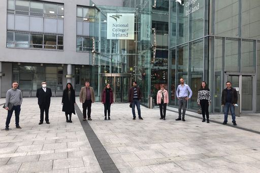 Participants of plenary in front of a building