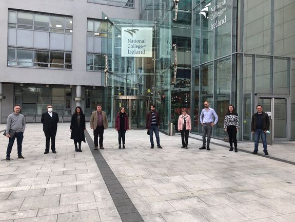 Participants of plenary in front of a building