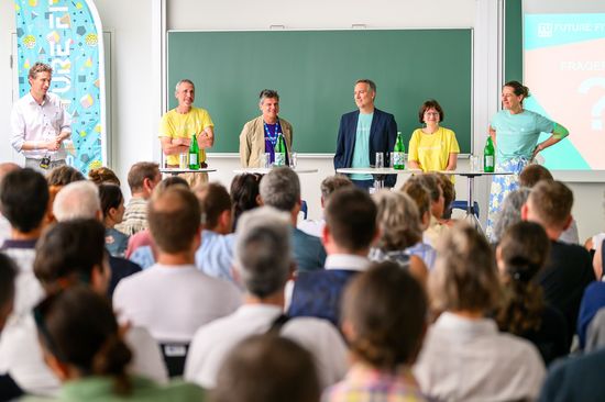 Rectorate team and Prof Hellmich on the podium at the fuTUre fit mid-term event