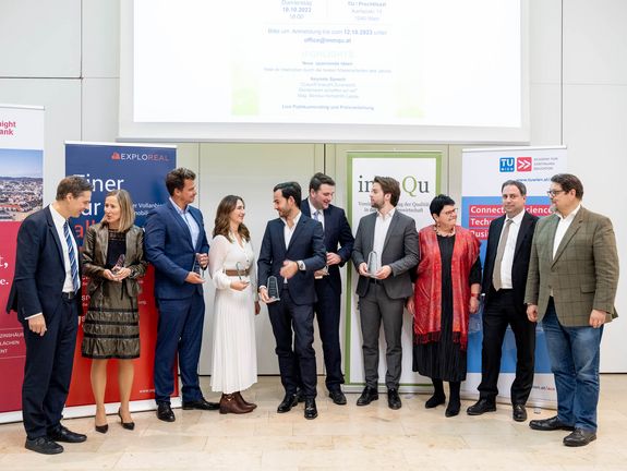 All award winners are gathered at the podium.