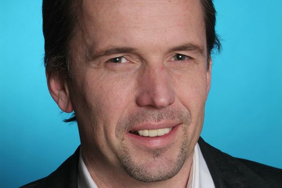 Christian Kern Portrait photo of Christian Kern on the bright blue background