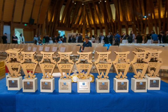 The Best Teaching Award trophies stand side by side on a table.