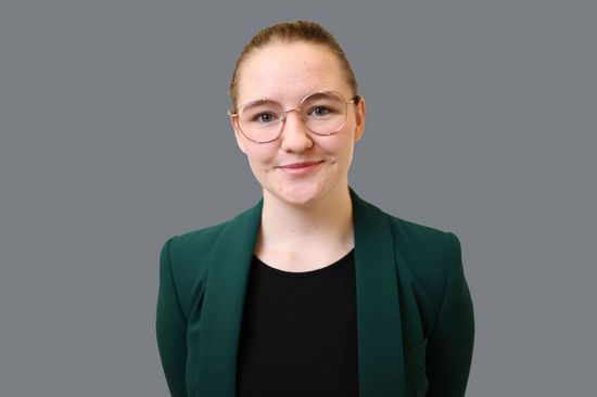 a woman in a green jacket