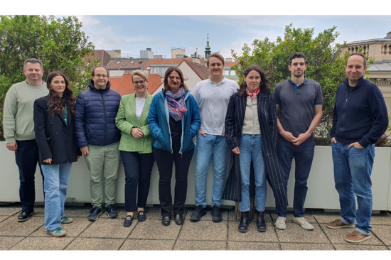 Group picture with nine persons taken on a roof deck.