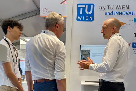 Dr. Joachim Rajek (TÜV/TVFA) at the TU Wien stand, FIA 2022
