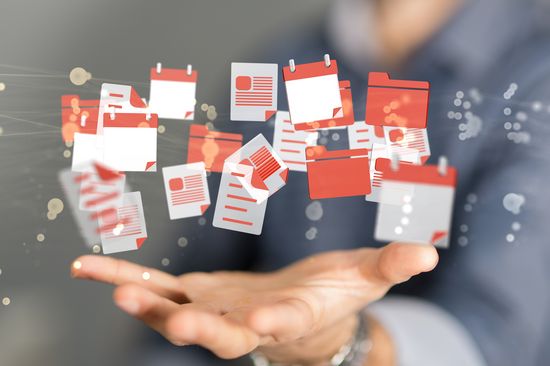 Decorative image: A photo of a hand, with graphic symbols for files, calendars, etc. floating above it.