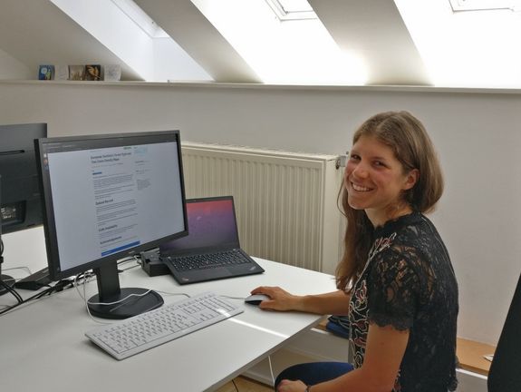 Woman sitting in front of computer showing dataset