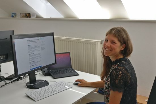Woman sitting in front of computer showing dataset