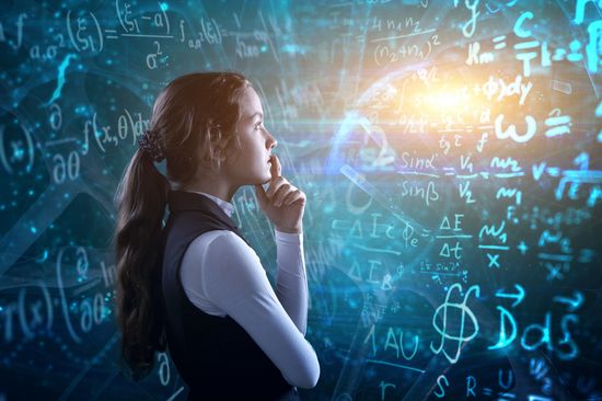 Student in front of the blackboard full with mathematic formulas 