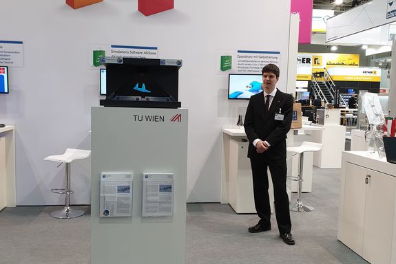 The NGSolve hologram pyramid at the TU Wien stand – in the back right Matthias Hochsteger (TU Wien).