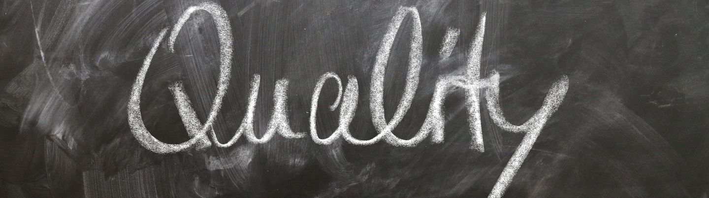 White lettering with chalk on a blackboard.
