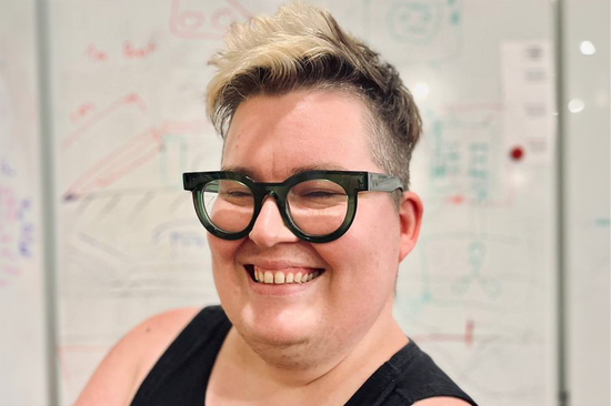 Portrait of Katta Spiel, in the background a written whiteboard.