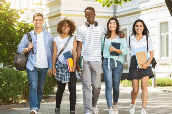 five students standing in front of the university