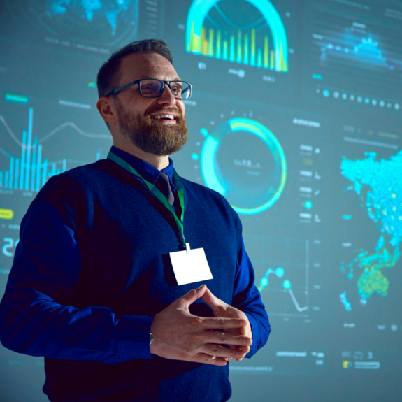 A man standing in front of a presentation screen
