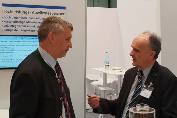 Prof. Dr. Andreas Werner talking to vice-rector Prof. Dr. Johannes Fröhlich at the TU Wien stand.