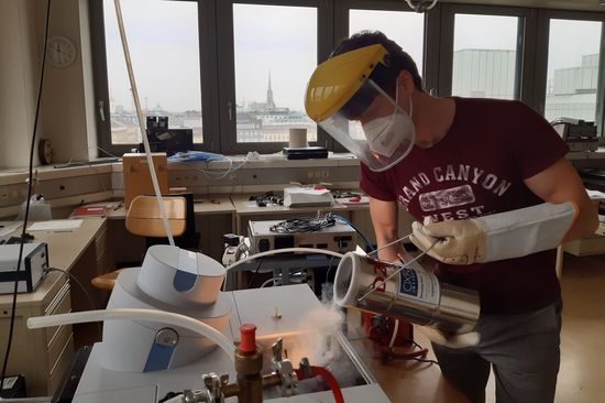 A scientist working with liquid nitrogen in the lab