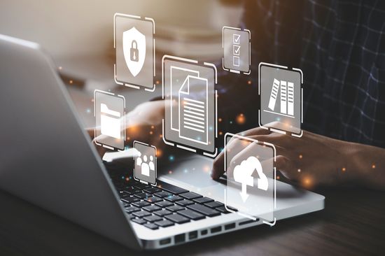 Photo of a person at a laptop, supplemented with Open Science symbols.