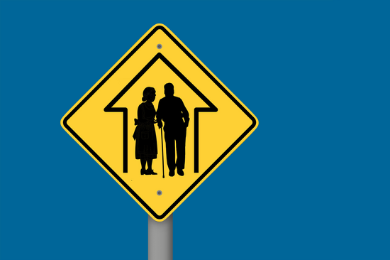 A yellow traffic sign depicting two elderly people pictogram. TU Vienna blue background. 